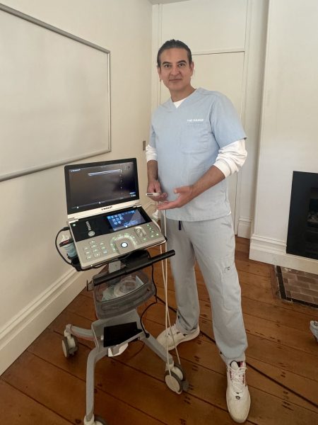 Dr Toshi performing an ultrasound facial assessment at The Manse Clinic, using advanced imaging to support precision and safety in cosmetic medicine.